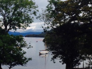 Swimmers in the distance heading up Coniston Water